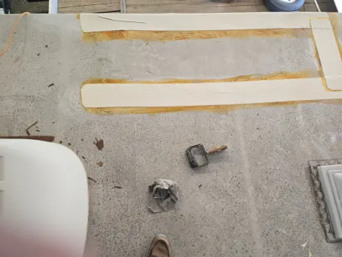 This is the cab over section This was approximately two foot by three foot area that started leaking and the plywood was delaminating inside so we went on and slice the roof open rolled it back Boy that's ugly isn't it with the yellow glue But we have a cure for that you'll see it in a minute